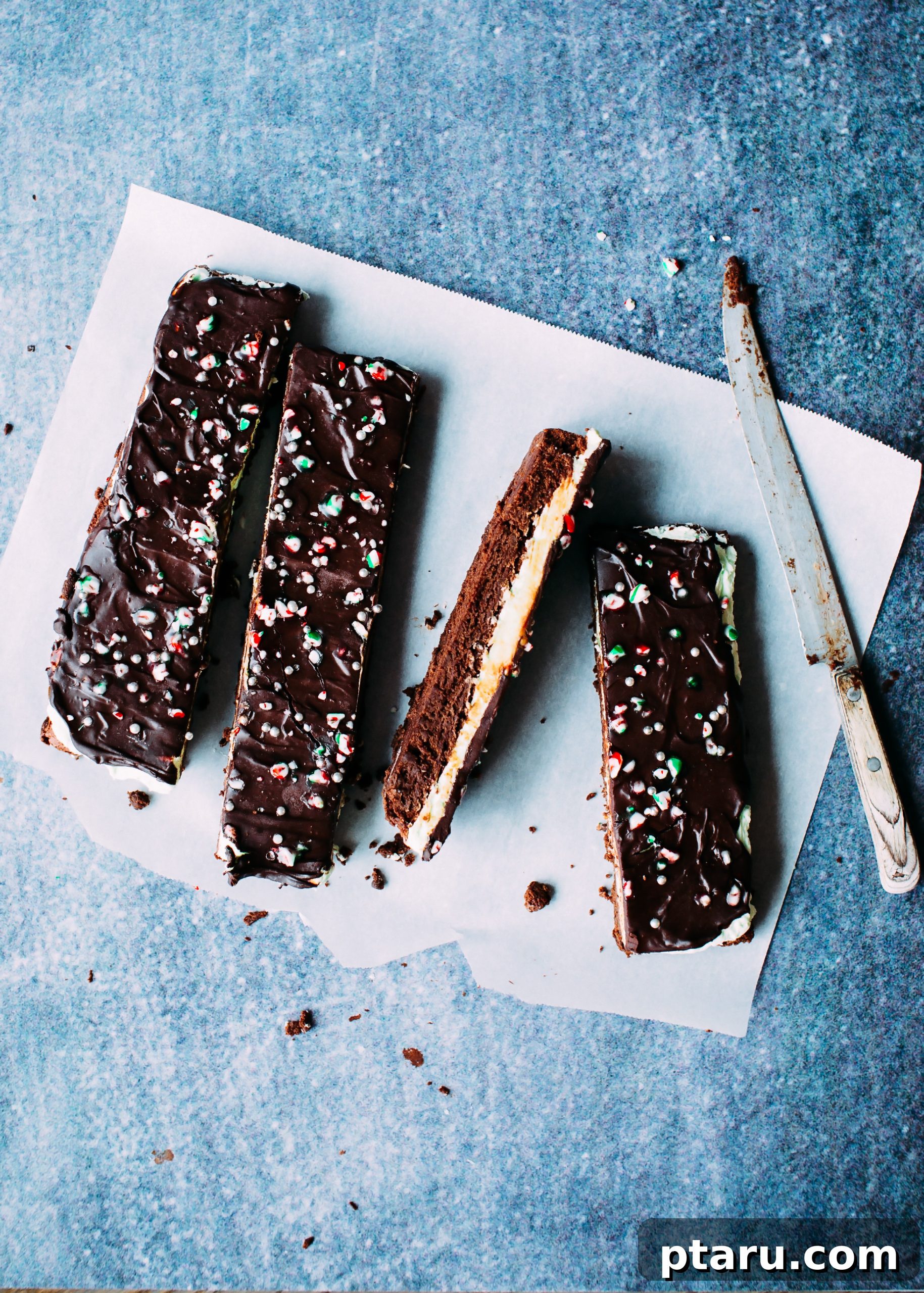 Decadent Peppermint Chocolate Brownies 4 Fudgy mint chocolate brownies, freshly cut into squares, showing off their layers