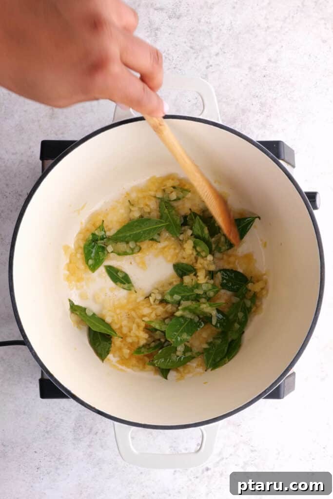 Chicken 65 India's Spicy Chicken Sensation 5 Frying onions and curry leaves for Chicken 65