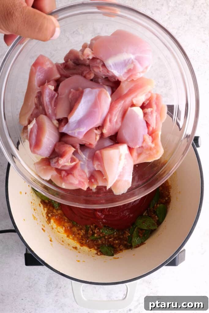 Chicken 65 India's Spicy Chicken Sensation 8 Adding chicken and ketchup to the mixture for Chicken 65