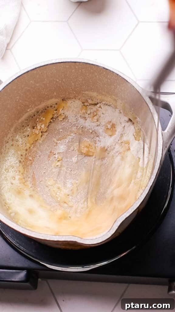 Easy Turkey Giblet Gravy No Drippings 11 The perfect caramel brown color of a roux in a saucepan, signaling it's ready for the broth to be added for gravy.