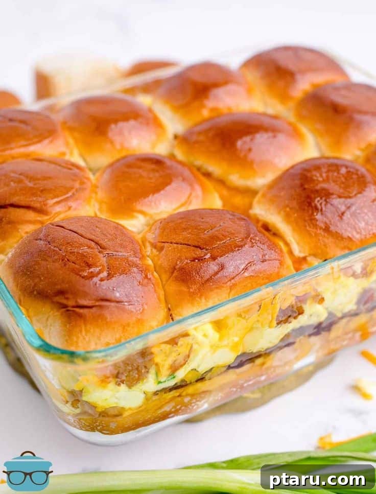 Rise and Shine: 23+ Sausage and Egg Breakfast Ideas 11 Golden-brown Sausage, Egg, and Cheese Breakfast Sliders served in a large casserole dish, ready for sharing.