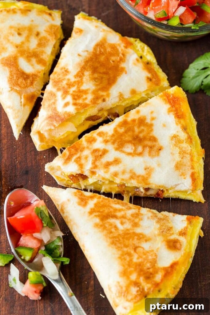 Rise and Shine: 23+ Sausage and Egg Breakfast Ideas 13 Golden-brown and cheesy Breakfast Quesadillas, showing their delicious filling, perfect for a quick and satisfying meal.