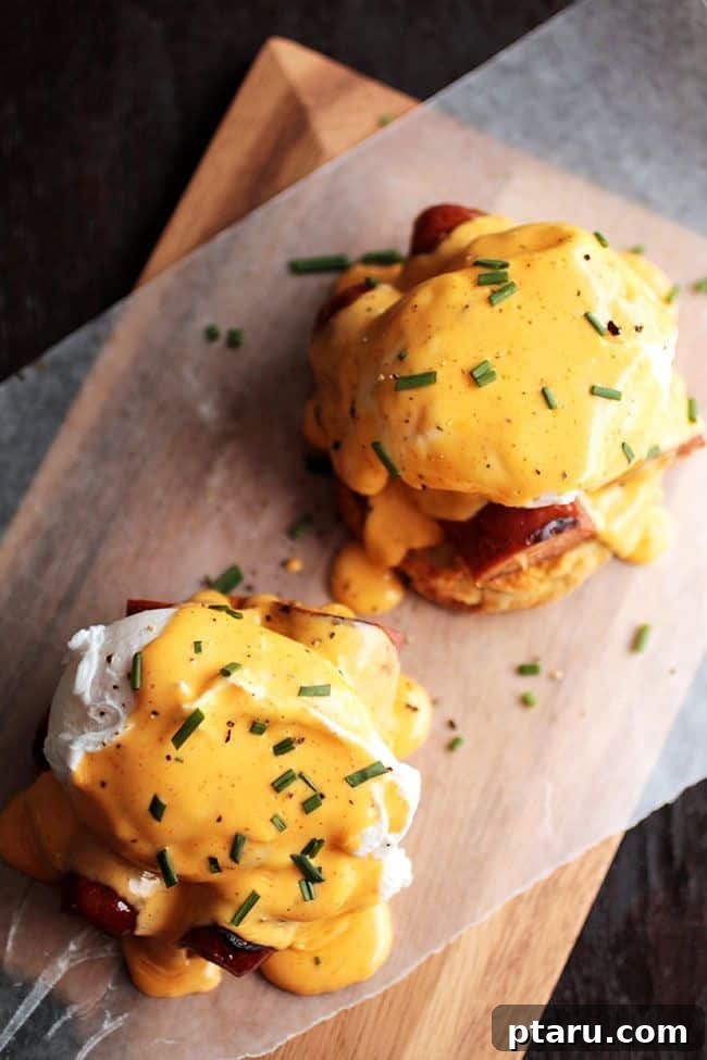 Rise and Shine: 23+ Sausage and Egg Breakfast Ideas 16 A beautifully composed Cajun Eggs Benedict, featuring poached eggs, spicy sauce, and a hint of green garnish.