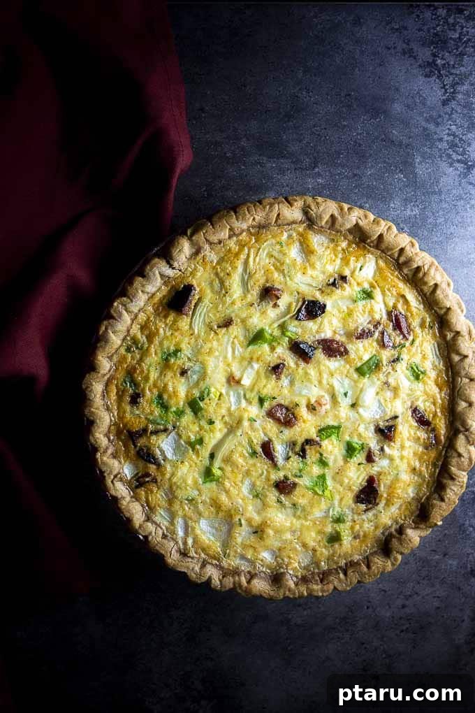 Rise and Shine: 23+ Sausage and Egg Breakfast Ideas 17 A rich and hearty Cheesy Shrimp and Sausage Quiche, with a golden crust and flavorful filling, ready to be served.