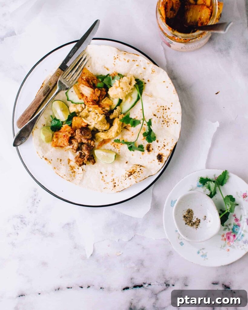 Rise and Shine: 23+ Sausage and Egg Breakfast Ideas 5 Vibrant Kimchi Sausage Breakfast Tacos, filled with colorful ingredients, served on warm flour tortillas.