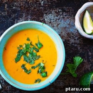 A bowl of Thai Coconut-Peanut Sweet Potato Soup