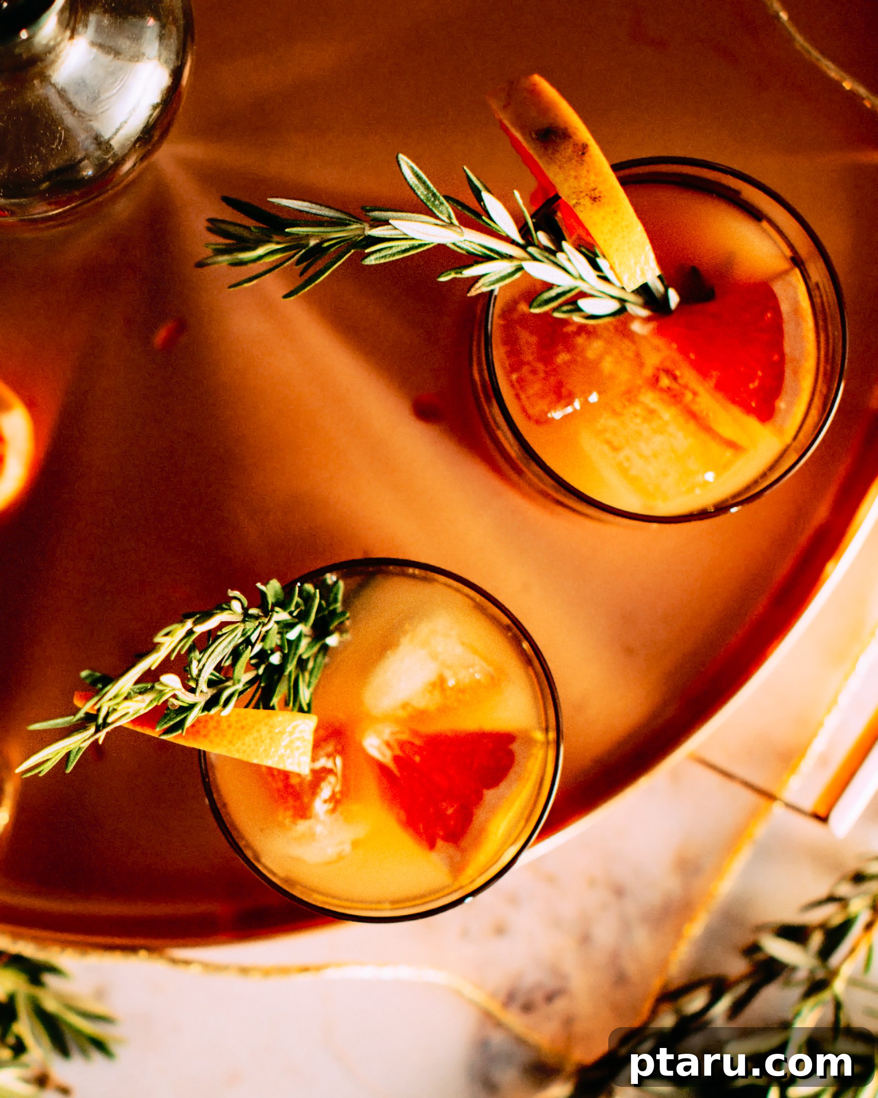 Rosemary Grapefruit Gin Sparkler 3 An arrangement of elegant copper barware, including a serving tray and cocktail glasses, ready for entertaining.