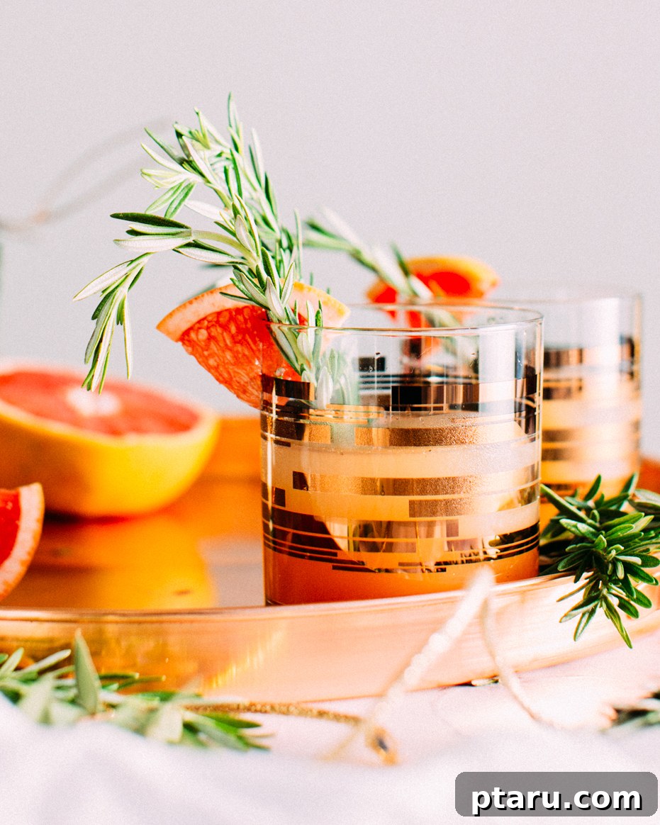 Rosemary Grapefruit Gin Sparkler 4 A close-up view of the Rosemary-Grapefruit Gin Fizz, showcasing its vibrant color and fresh garnish.