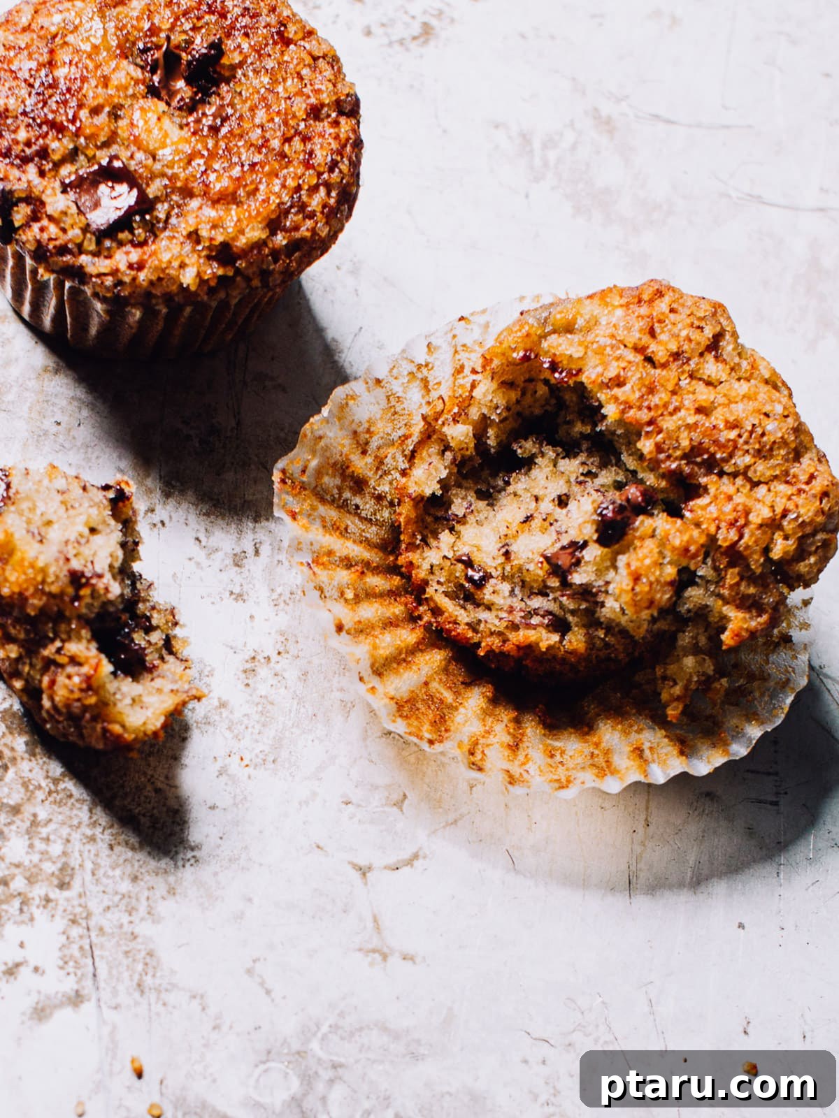 Golden Banana Bran Muffins 2 Perfectly baked, soft Banana Bran Muffins with chocolate chips on a cooling rack.