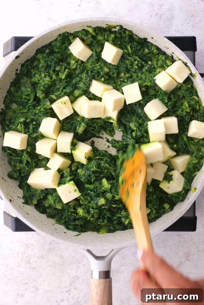 Creamy Spinach and Paneer Delight 3 Adding paneer to saag paneer gravy.