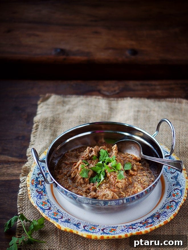 Velvety Cashew Chicken Curry 2 Delicious Cashew Chicken Curry in a serving bowl with a spoon