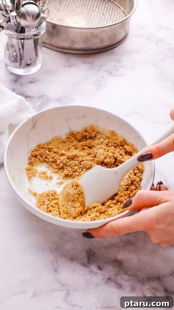 The Ultimate Philadelphia Cheesecake Guide 5 Mixing graham cracker crumbs and melted butter to prepare the cheesecake crust