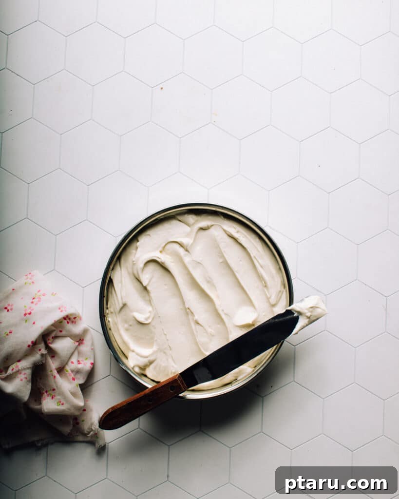 The Ultimate Philadelphia Cheesecake Guide 10 Cheesecake filling poured into a springform pan with crust, ready for the oven
