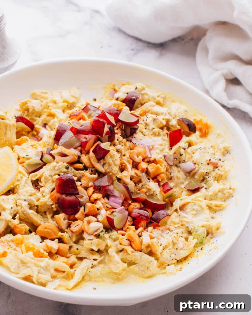 Flavorful Curried Chicken Salad with Sweet Grapes 2 A close-up of vibrant Curry Chicken Salad with Grapes, showing tender chicken pieces, halved red grapes, and a creamy dressing, ready to be served.