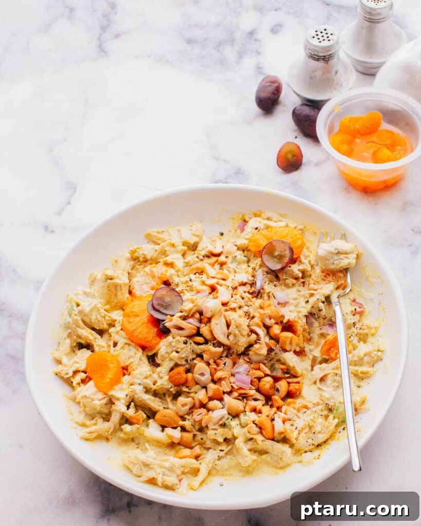 Flavorful Curried Chicken Salad with Sweet Grapes 4 A bowl of Curry Chicken Salad with Grapes, garnished with mandarin oranges, highlighting its vibrant and inviting appearance.