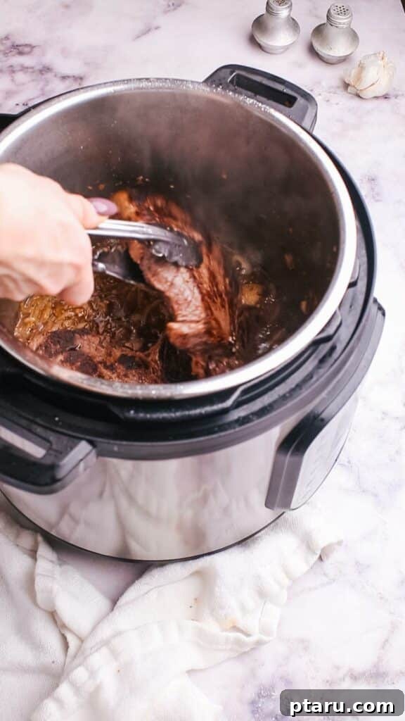 Meltingly Tender Instant Pot Steak with Rich Pan Sauce 10 taking out steak from instant pot