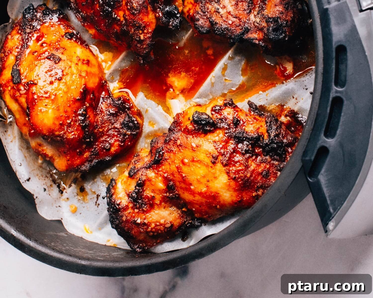 Air Fryer Boneless Thighs: Unbelievably Juicy, Incredibly Fast 7 Checking on Boneless Chicken Thighs in Air Frying Basket during cooking.