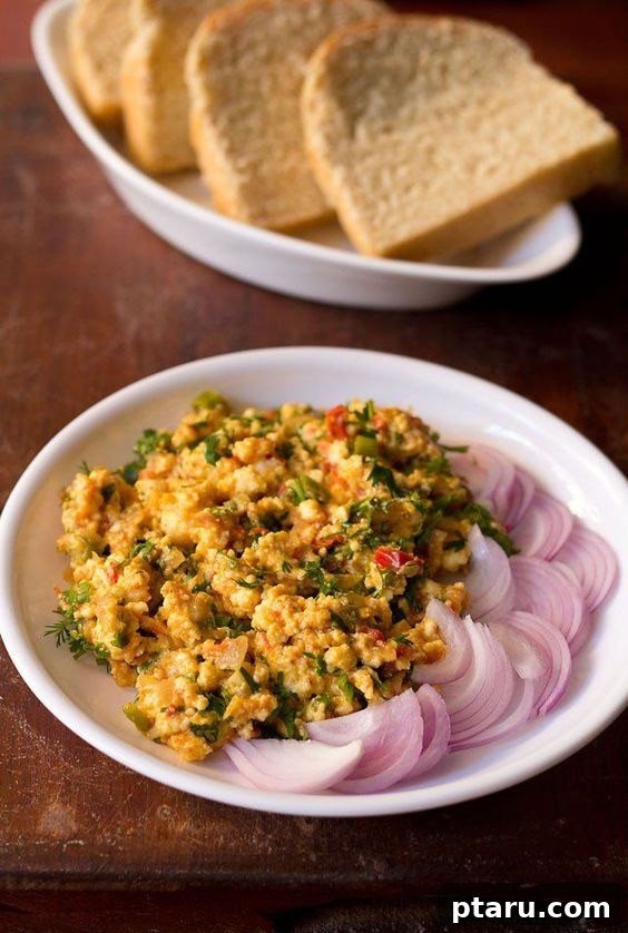 Over 50 Irresistible Paneer Recipes 19 Paneer Bhurji in plate with onion slices, a hearty breakfast or side.
