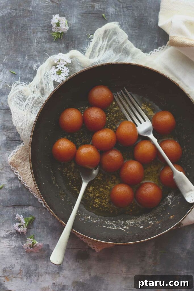Over 50 Irresistible Paneer Recipes 50 Paneer Gulab Jamun, glistening in syrup.