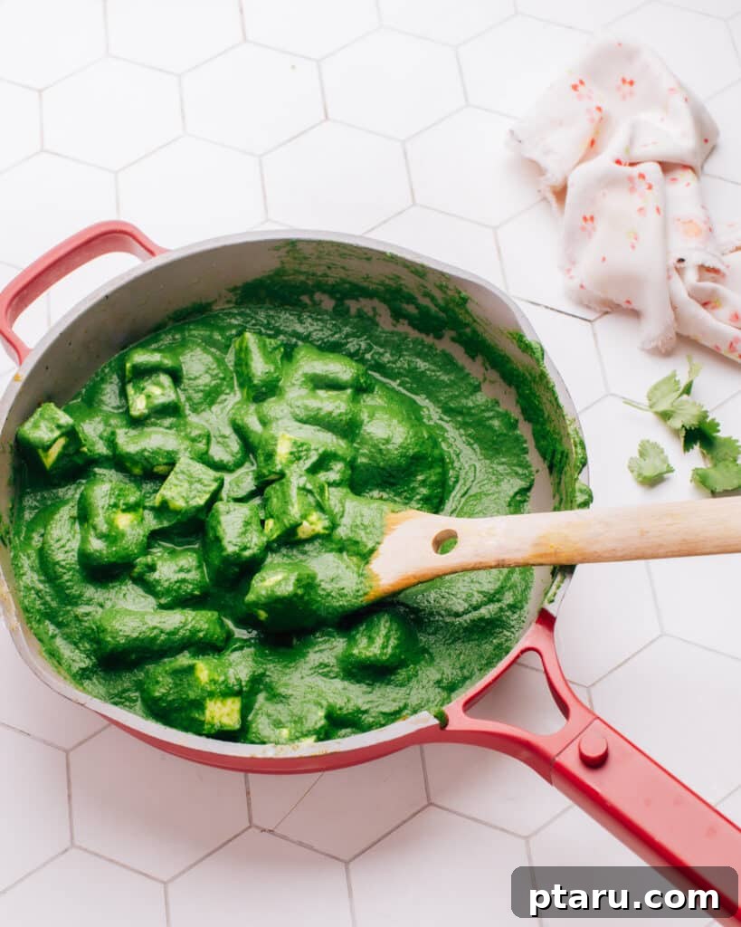 Over 50 Irresistible Paneer Recipes 8 Palak Paneer recipe in a pan with a spoon, vibrant and healthy.