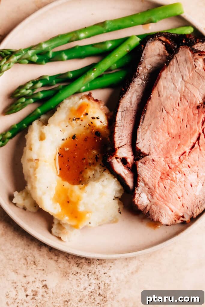 Melt in Your Mouth Air Fryer Roast Beef 2 Perfectly cooked Air Fryer Roast Beef served with creamy mashed potatoes and rich gravy.