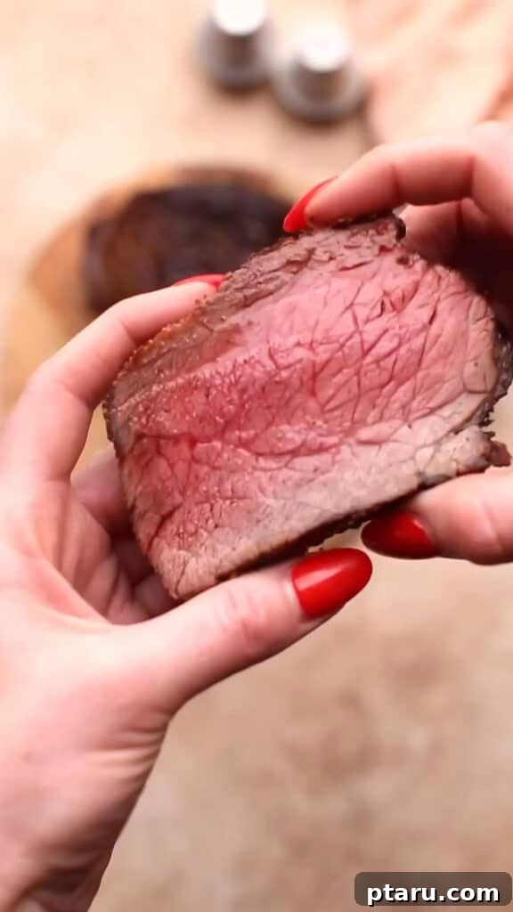 Melt in Your Mouth Air Fryer Roast Beef 8 A perfectly sliced piece of air fryer roast beef, showing its juicy interior.