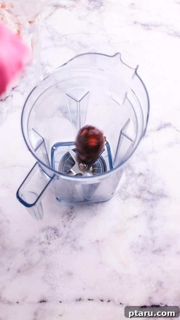 Velvety Beet Pasta Sauce 5 Adding cooked beets to a blender with broth and onions.