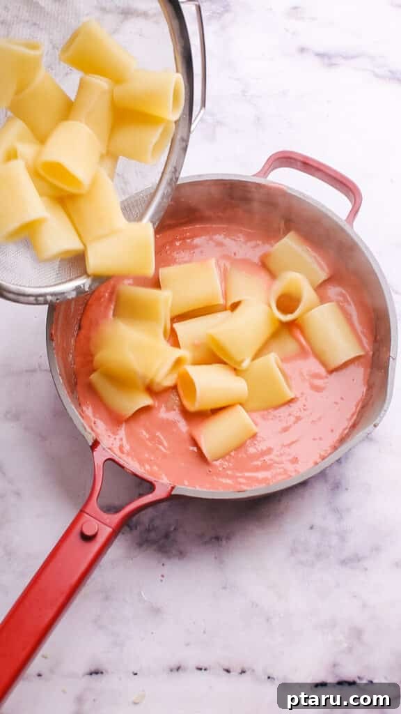Velvety Beet Pasta Sauce 7 Adding cooked pasta to the rich beet sauce.