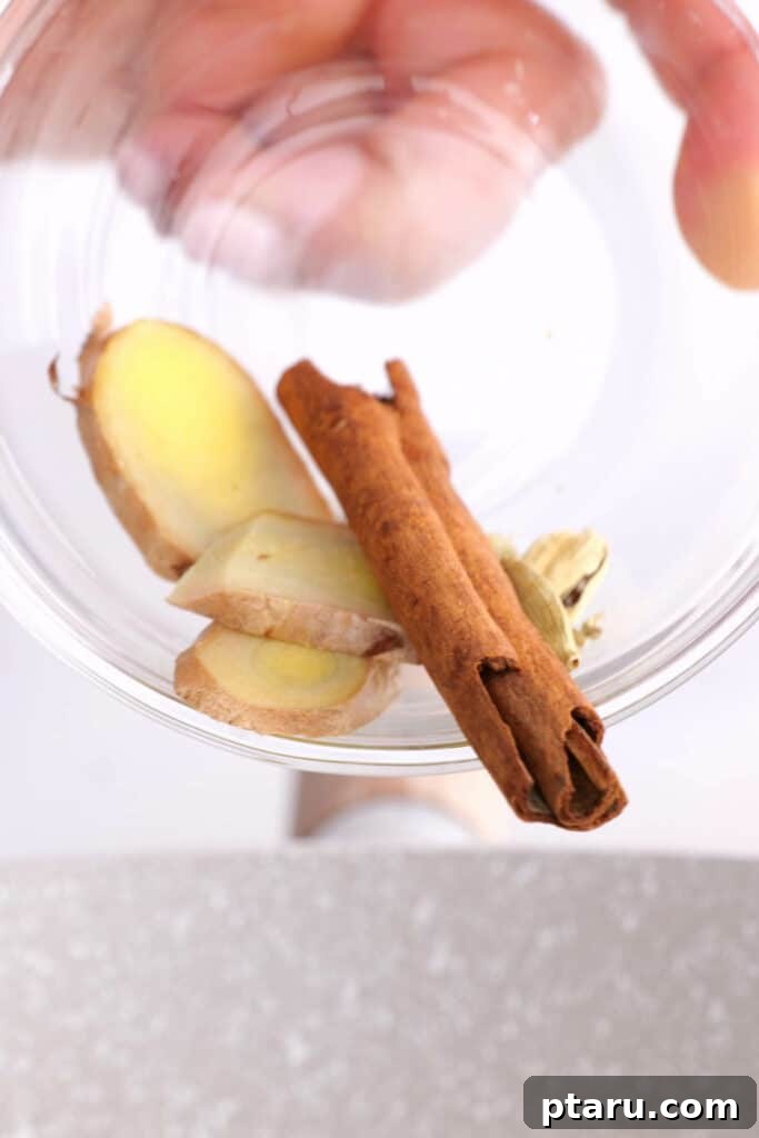 Secrets to Authentic Indian Masala Chai 6 A selection of whole spices including cardamom pods, cinnamon sticks, ginger, and fennel seeds, ready for making Homemade Indian Chai.