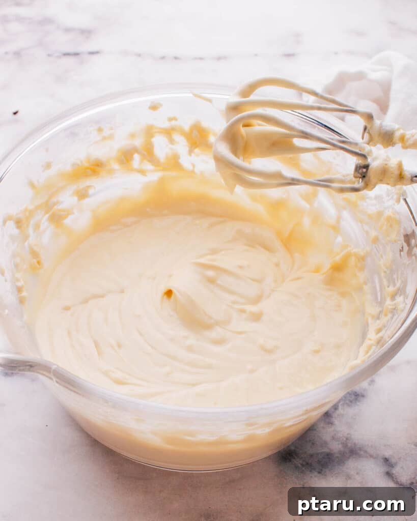 Spiced Caramel Apple Cheesecake 5 Creamy cheesecake filling in a bowl, ready to be poured into the crust.