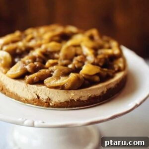 Caramel Apple Cheesecake on a cake stand, close-up view.