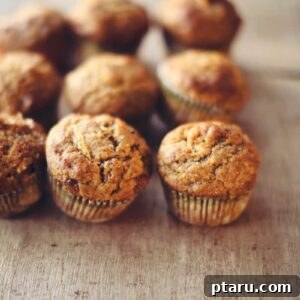 Tender Spiced Pumpkin Zucchini Muffins 7 Pumpkin Zucchini Muffins on a table.