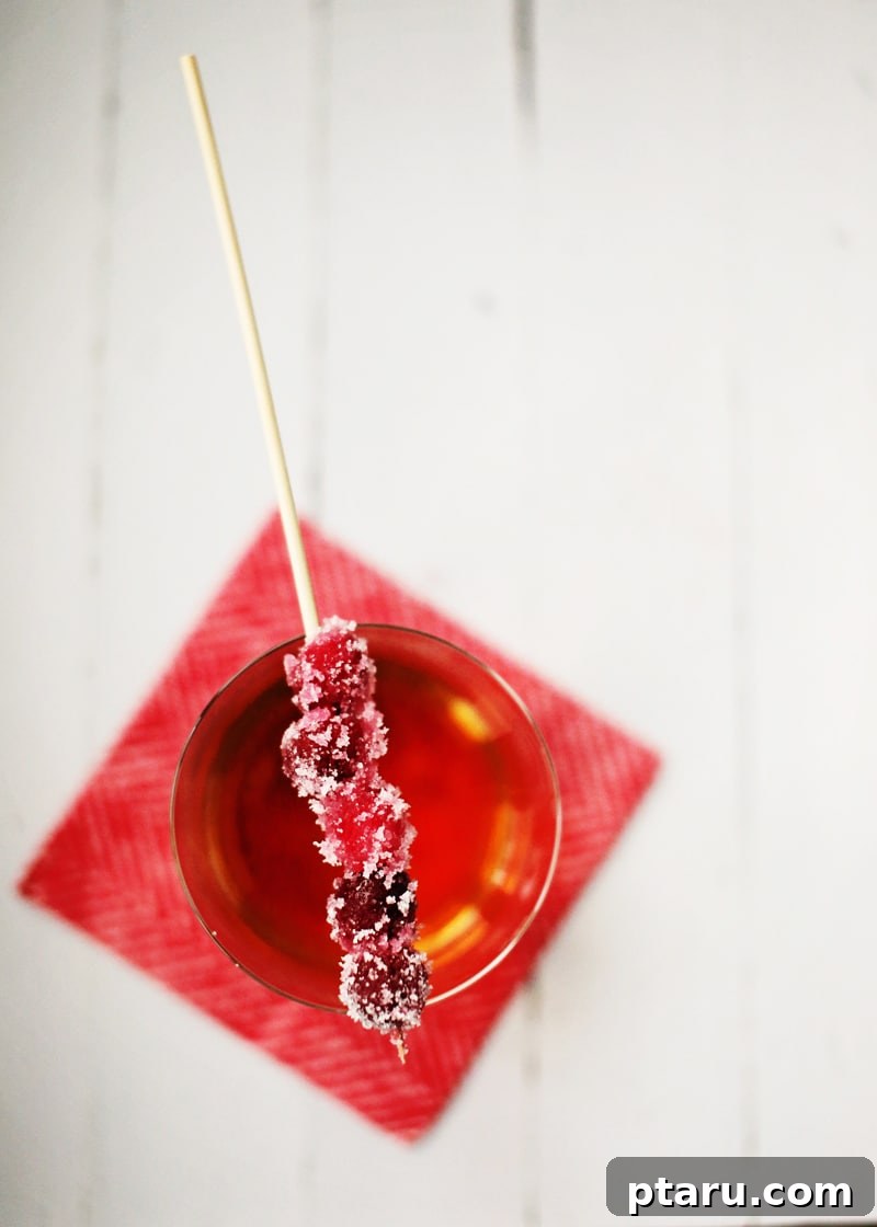 Crystal Cranberries 5 Sugared cranberries adorning a festive holiday cocktail.