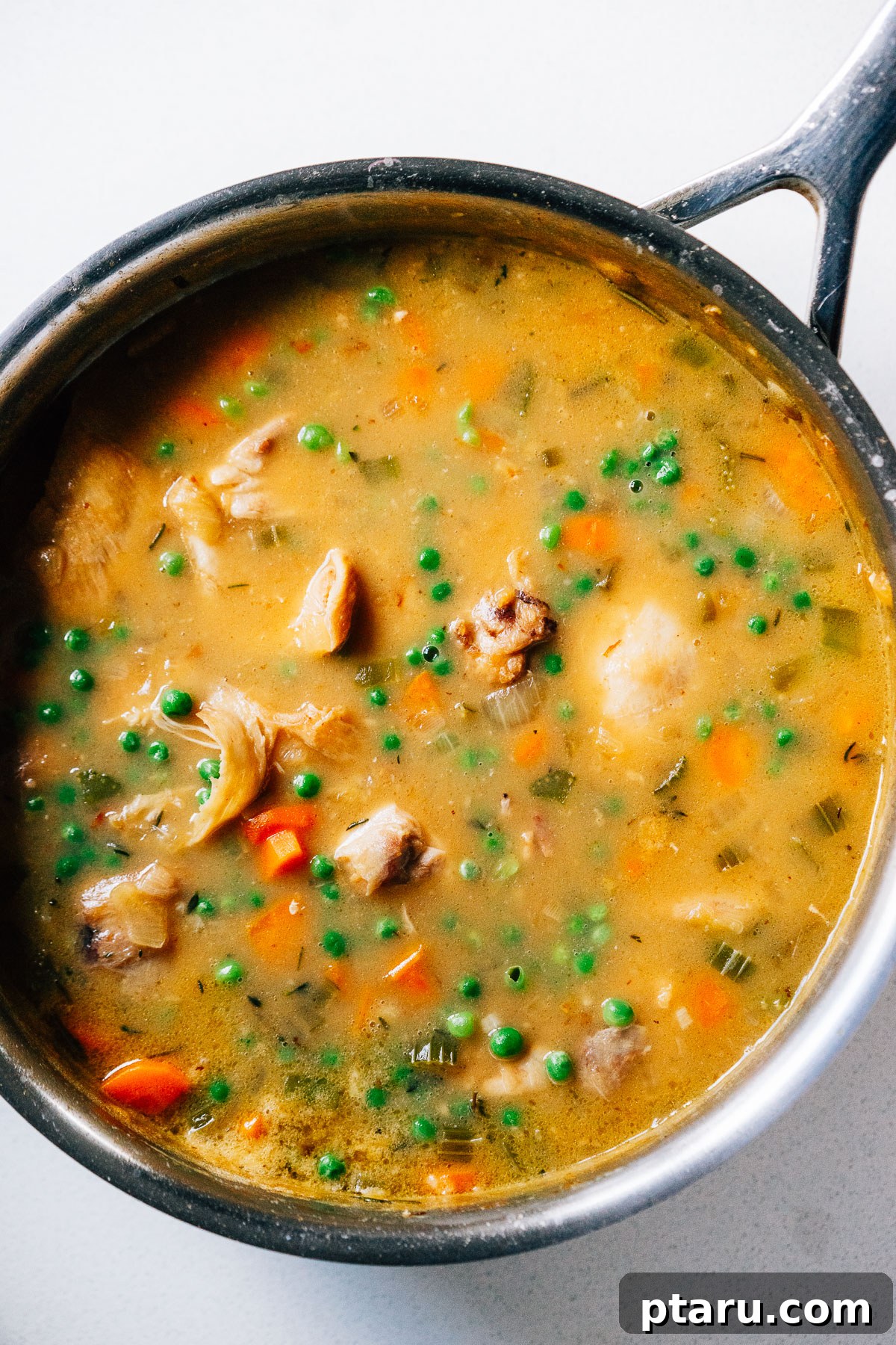 Golden-Crusted Turkey Pot Pie 5 Steps of making Chicken Stew with Biscuit Topping Recipe - second image showing adding broth to the roux