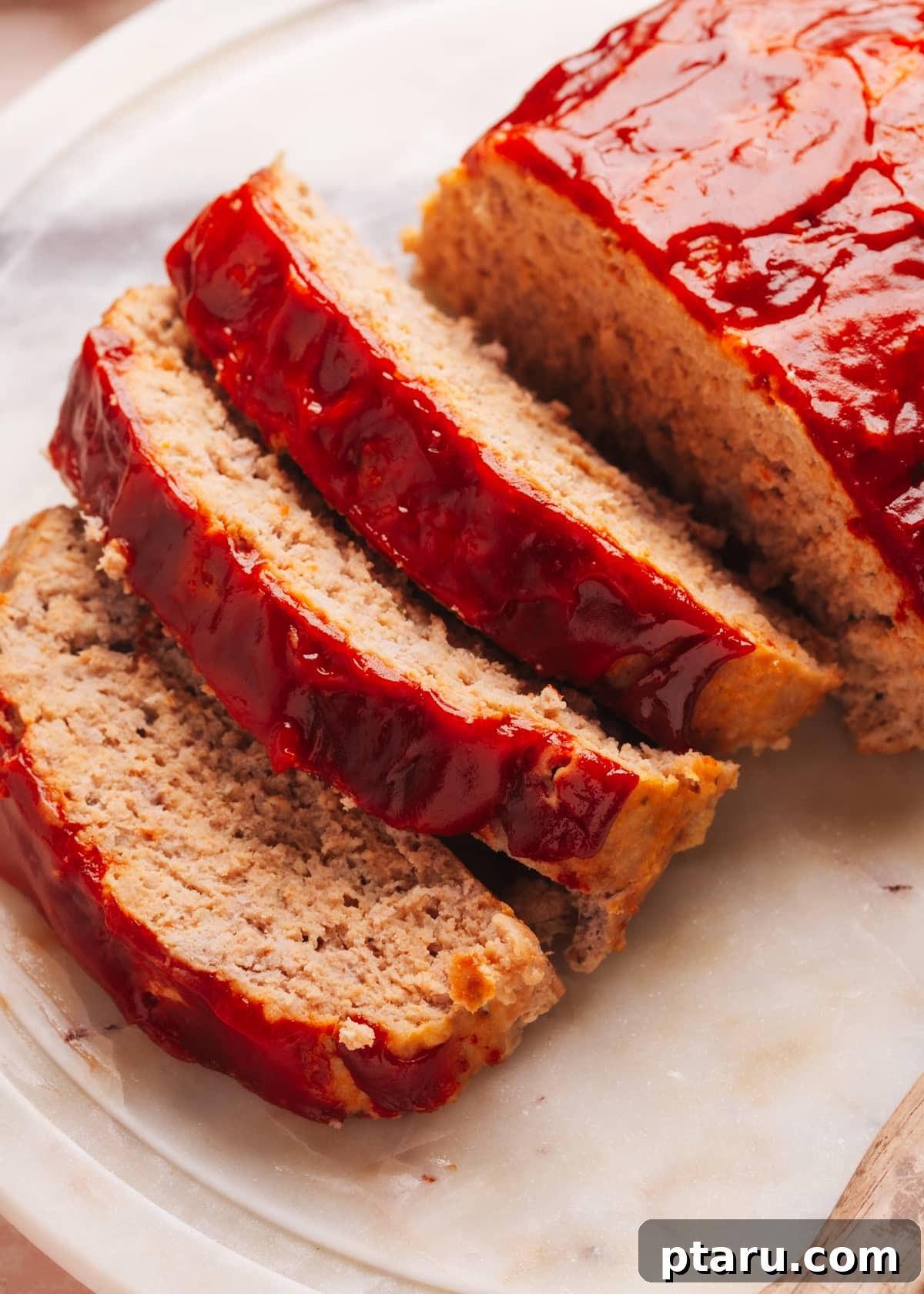 The Ultimate Juicy Turkey Meatloaf 2 Close-up shot of sliced, perfectly cooked, and moist turkey meatloaf ready to be served.