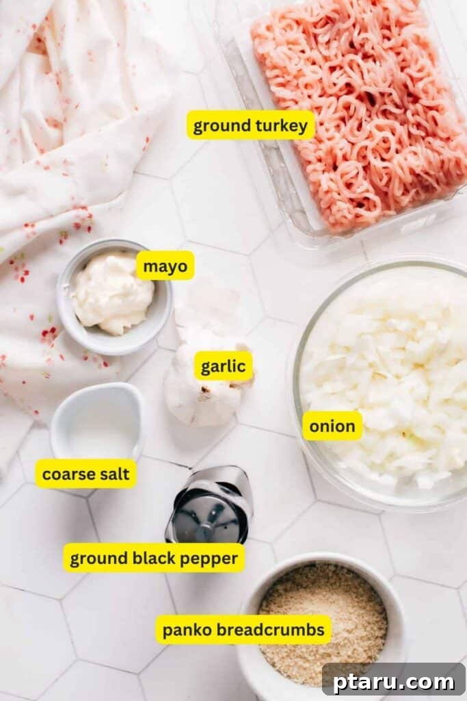 The Ultimate Juicy Turkey Meatloaf 3 A selection of fresh ingredients laid out, including ground turkey, breadcrumbs, milk, olive oil, onions, garlic, and herbs, ready for making turkey meatloaf.