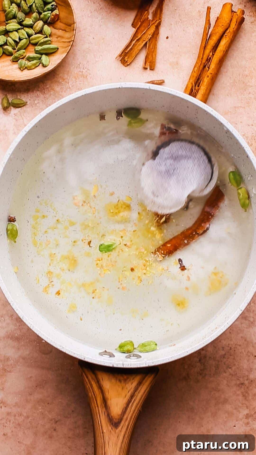 Brew Your Own Rich Chai Concentrate for Incredible Lattes 6 A mix of whole spices like cinnamon, ginger, cloves, and cardamom in a pot of water.