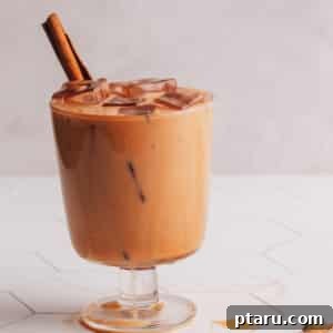 Iced Chai Latte in Glass with cinnamon stick