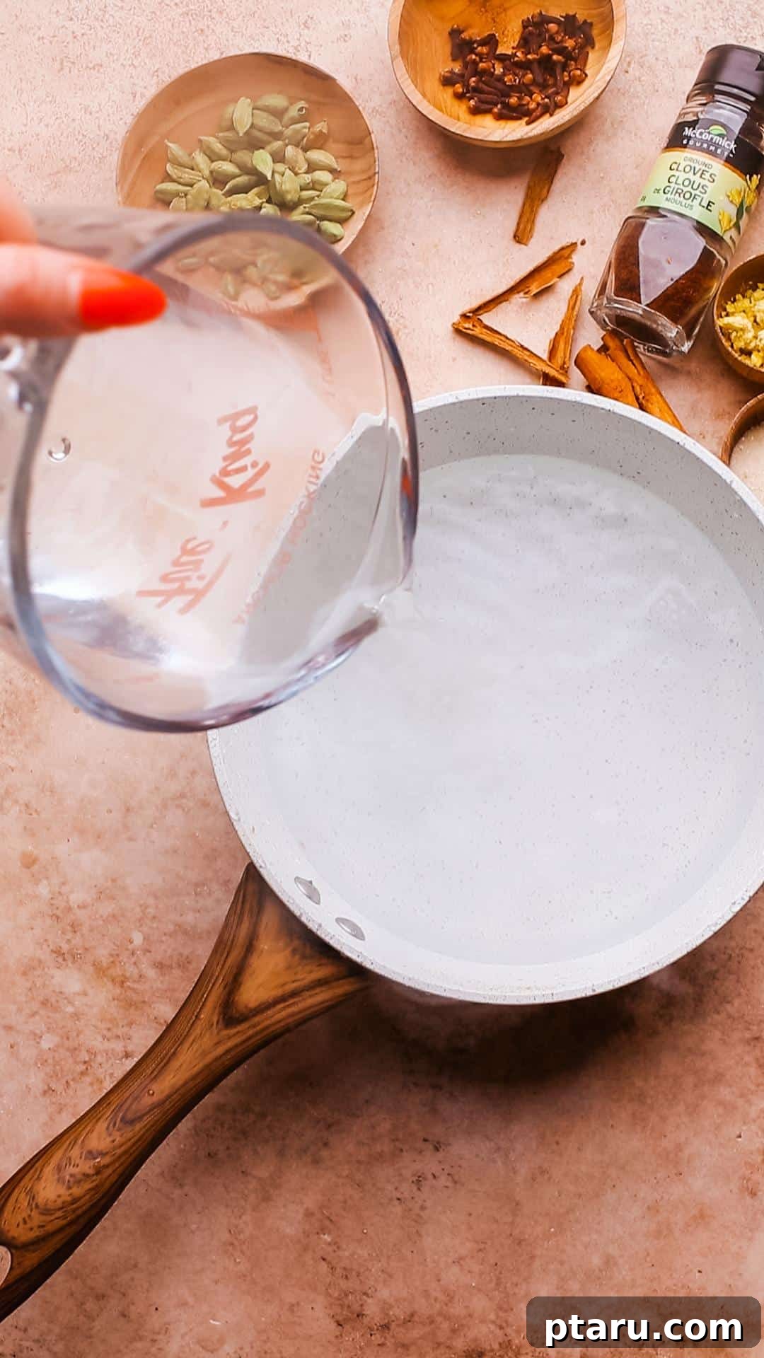 Perfectly Spiced Iced Chai Latte Made Easy 4 Adding water to a medium saucepan, the first step in preparing the chai concentrate base.