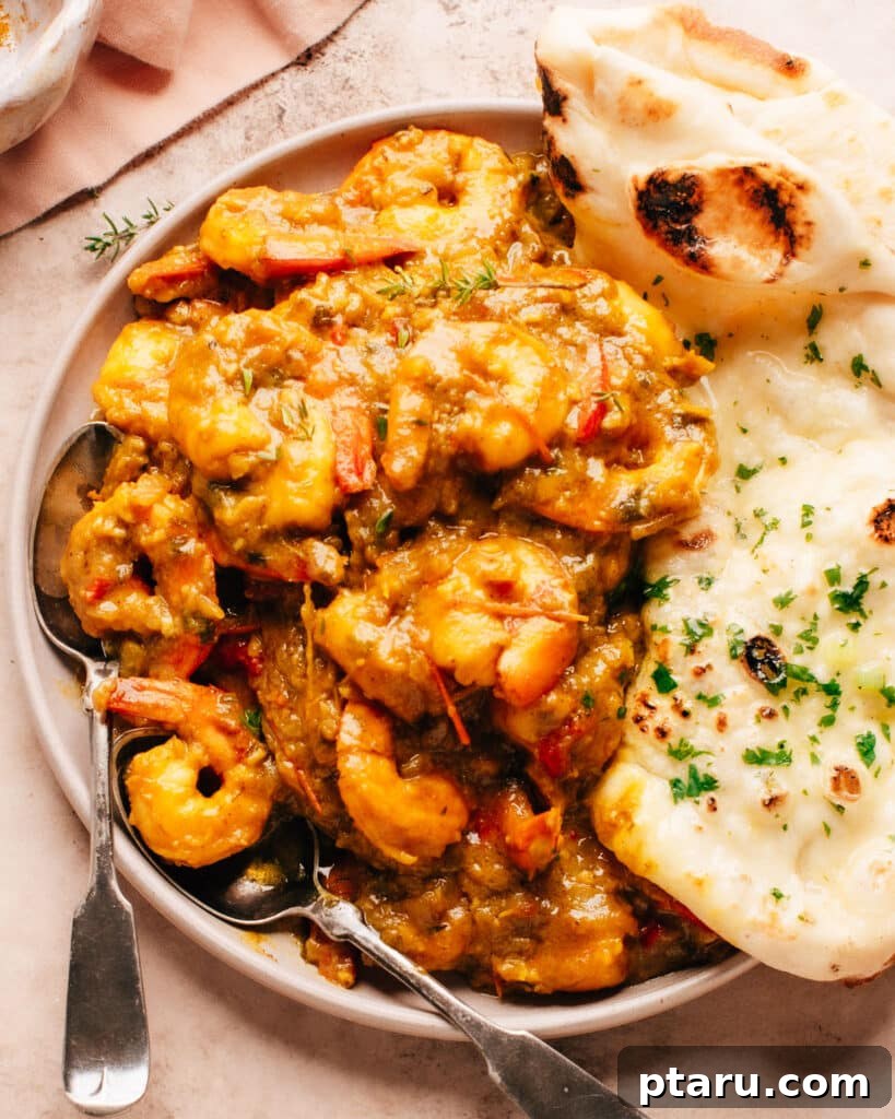 Irresistible Indian Dinners, Made Simple 20 Flavorful Jamaican Curry Shrimp served on a plate with naan bread.