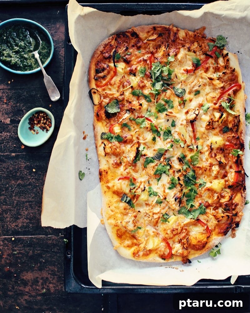 Irresistible Indian Dinners, Made Simple 21 Homemade Butter Chicken Pizza, an Indian fusion delight, on a table.