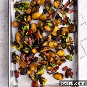 Crispy Roasted Brussels Sprouts with Maple and Bacon on a baking sheet with parchment paper.
