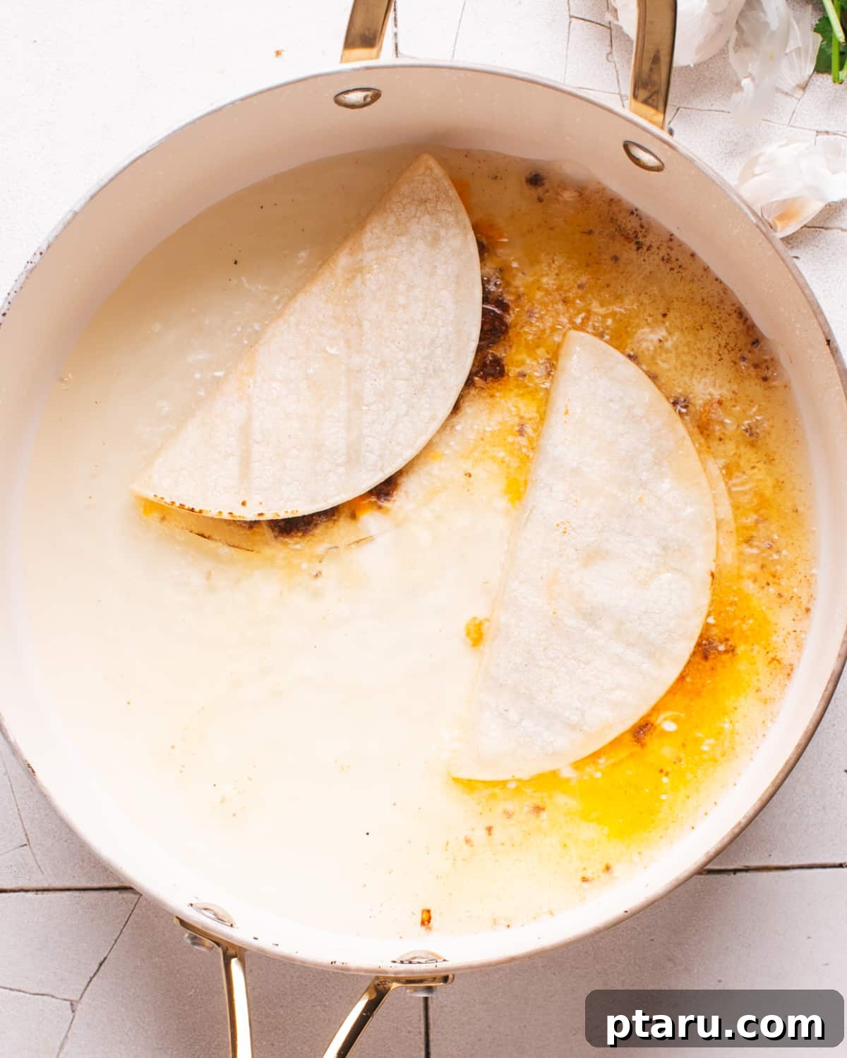 Crispy Fried Tacos Made Easy 7 Close-up of three filled tacos frying in hot oil in a pan, achieving a perfect golden crisp.