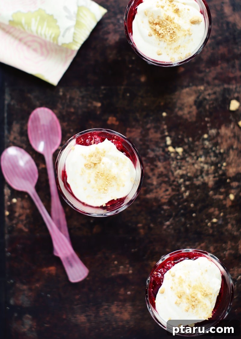 Effortless Raspberry Cheesecake Cups 2 Delicious No-Bake Raspberry Cheesecake Pots layered in a glass with fresh raspberries
