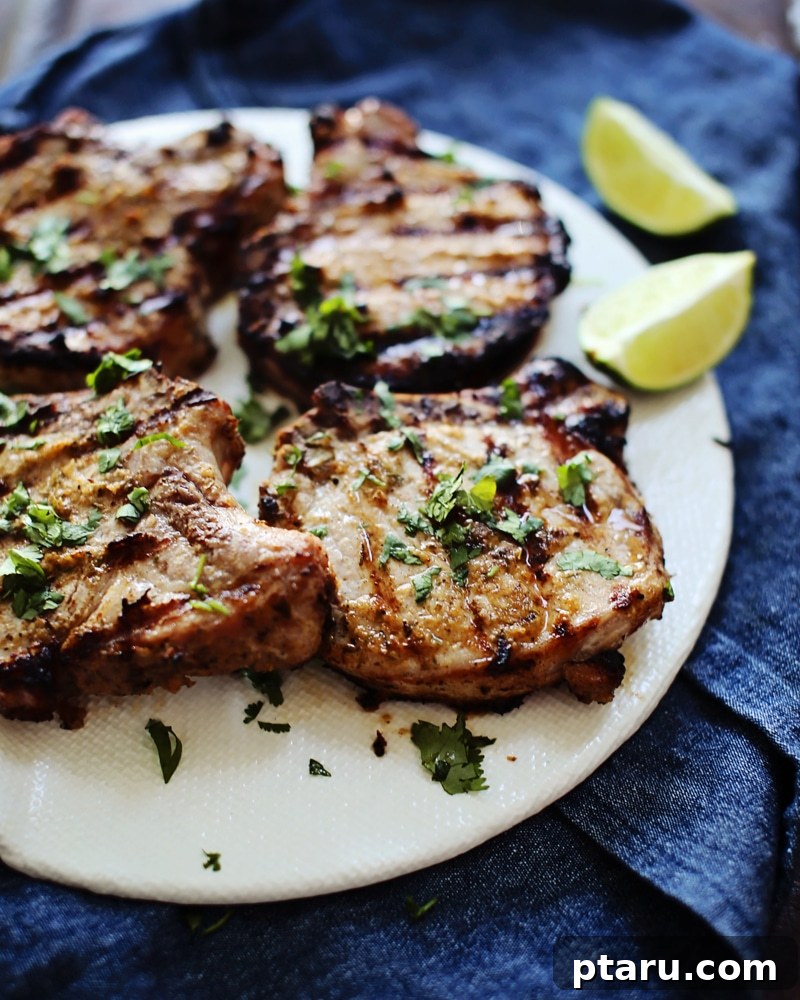 Zesty Grilled Jerk Pork Chops 3 Close-up of a grilled pork chop with a vibrant jerk marinade, fresh cilantro and lime.