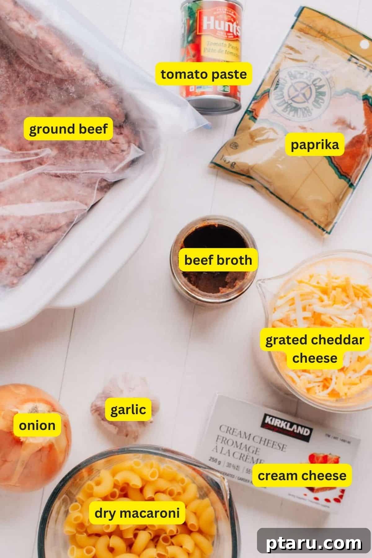 No-Fuss Cheeseburger Dinner 3 Cheeseburger Casserole Ingredients. A spread of fresh ingredients including ground beef, macaroni, cheese, onion, and spices.