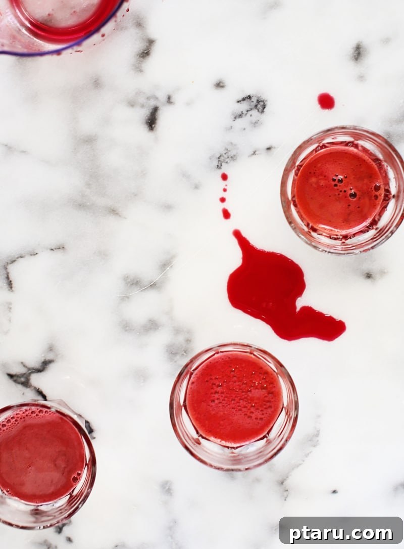 Essential Apple Beet Carrot Nectar 4 A Moulinex juicer actively extracting juice from fresh produce, showcasing its slow-press technology