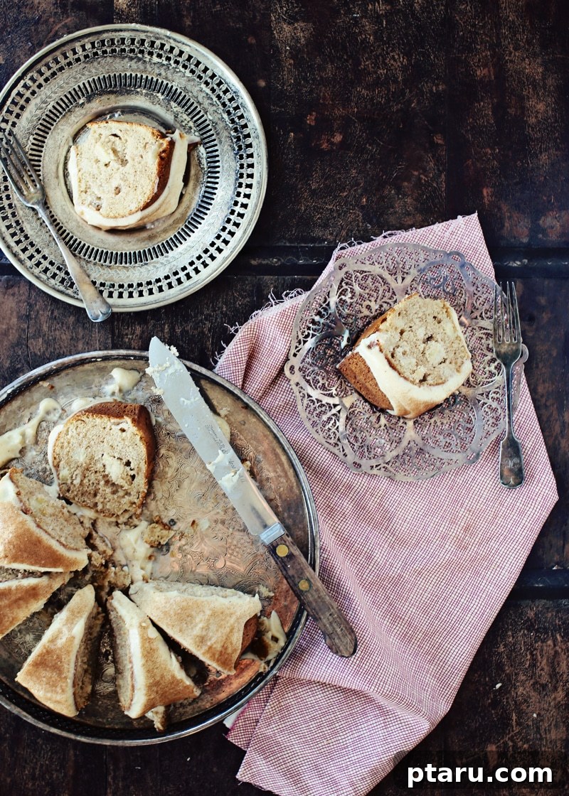 Chai Kissed Apple Cake with Creamy Frosting 5 A whole chai apple cake sliced on a plate, ready to be served.