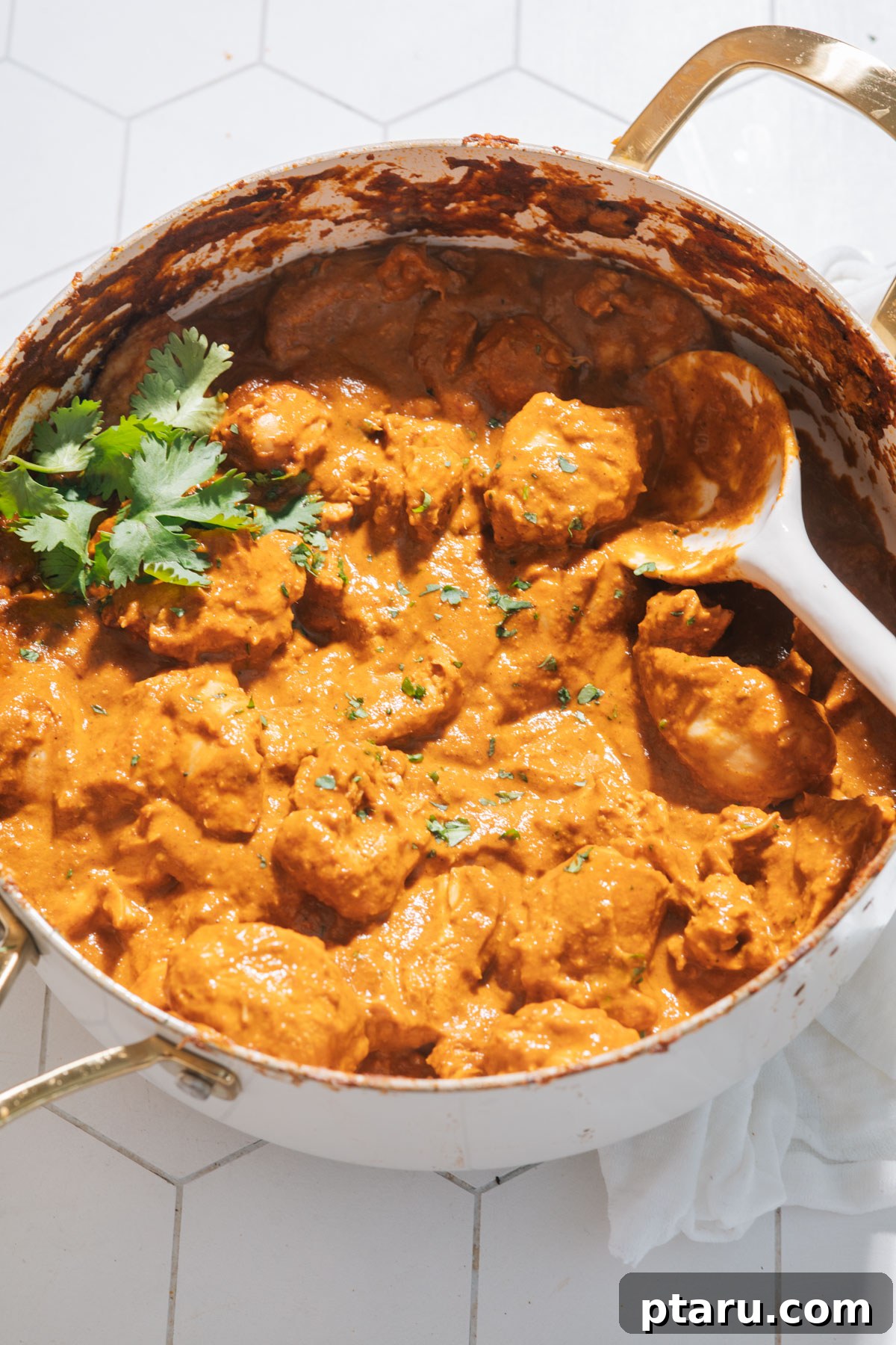 The Ultimate Butter Chicken Recipe: Restaurant-Level Perfection at Home 14 Butter chicken in a saucepan with cilantro.