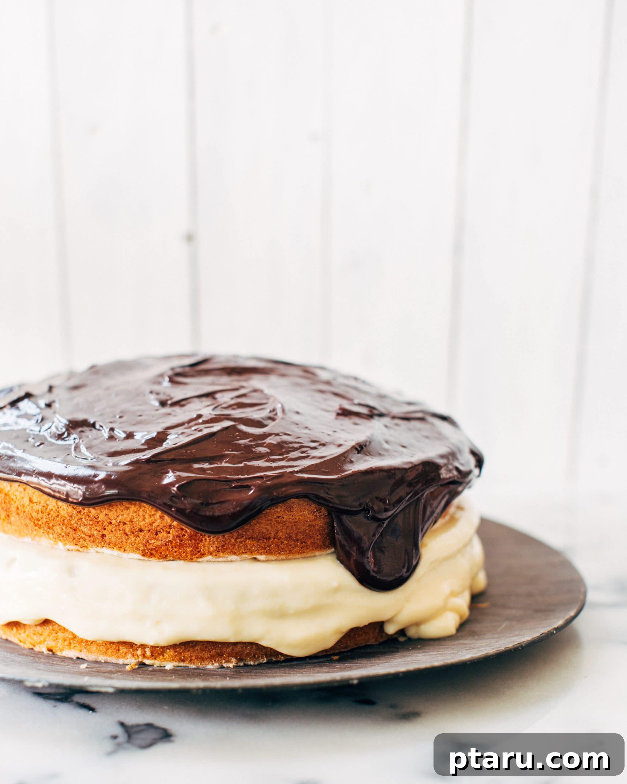 Chocolate-Topped Boston Cream Dream 3 Close-up of a generous slice of Boston Cream Pie with ganache dripping